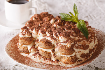 Tasty tiramisu on a plate and espresso coffee close-up. Horizontal
