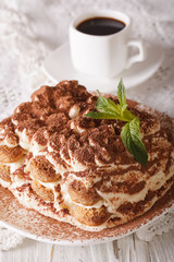 Tasty tiramisu on a plate and espresso coffee close-up. vertical

