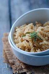 Raw pasta on wooden background