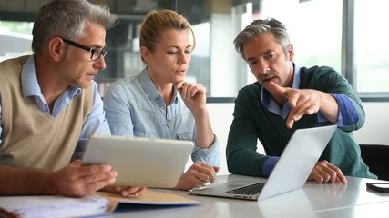 Business people in a meeting using tablet - Powered by Adobe