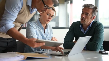 Business people in a meeting using tablet - Powered by Adobe