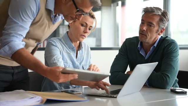 Business People In A Meeting Using Tablet