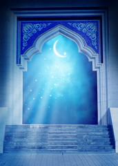 Ramadan Kareem background.Mosque door with shiny crescent moon