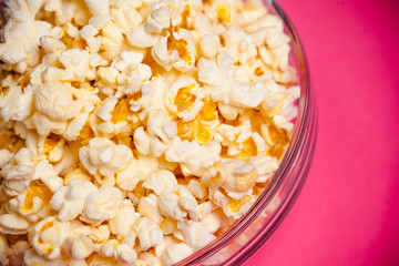 bowl with popcorn on red background