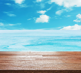 Fototapeta na wymiar Wooden table top on bright blue sea