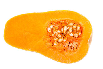 Half of orange pumpkin with seeds isolated on white.
