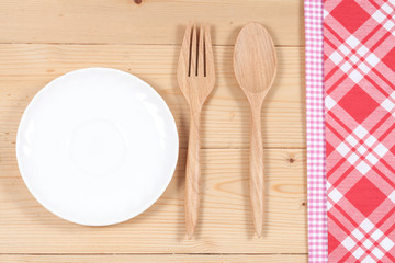 Color tablecloth, spoon, fork on  table background