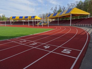 Running track on the sport stadium with covered grandstand 