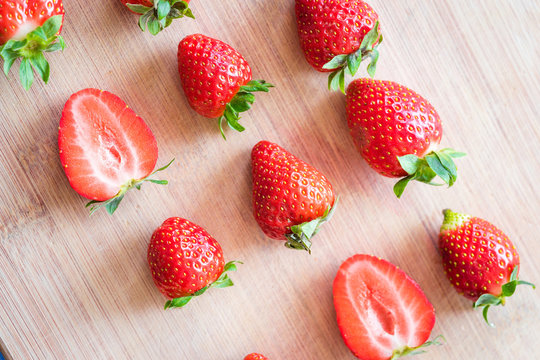 Strawberries on a wooden table. Arranged in a order.