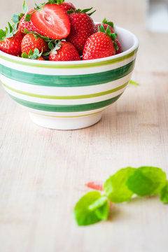 Fresh strawberries in a bowl. Selective focus. Vertical view.