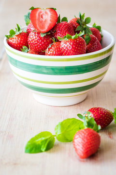 Fresh strawberries in a bowl. Selective focus. Vertical view.