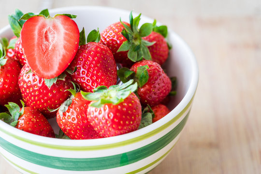 Top view of fresh strawberries in a bowl. Horizontal shot. Selective focus.