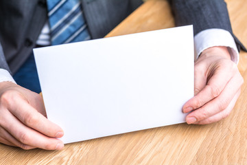 hand of businessman and blank white paper
