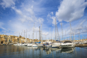 Fototapeta na wymiar Malta - Yacht marina at Birgu with blue sky and clouds