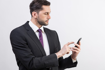 Young business man checks his phone