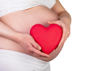 Pregnant woman with red heart in hands isolated on white.