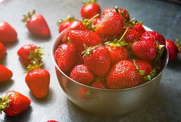 Fresh strawberries on dark stone background