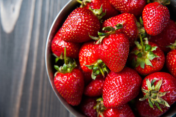 Fresh strawberries on old wooden background