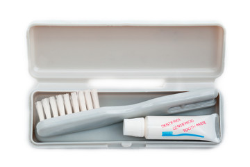 close-up of toothbrush and toothpaste in case.