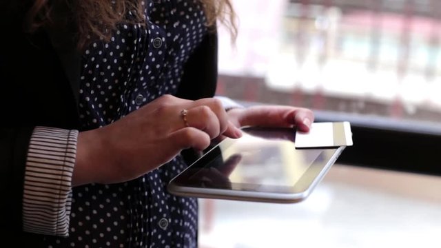 Business Woman is Using a Tablet and Credit Card