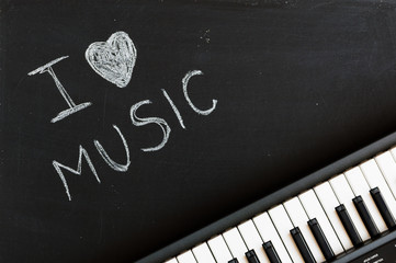 Music keyboard on blackboard background - I love music