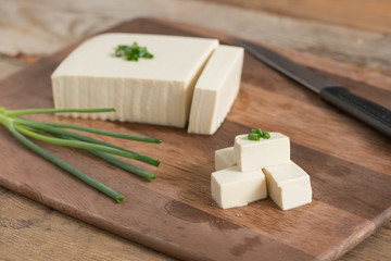 Fresh tofu on cutting board.