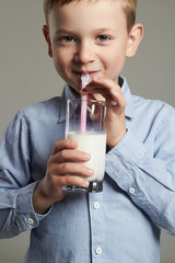 happy Child drinking milk.Little smiling Boy enjoy milk cocktail. Healthy life