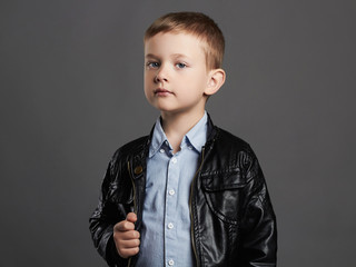 Fashionable child in leather coat.stylish little boy.funny 6 years old kid