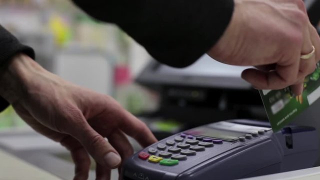 Girl is Shopping, Paying by Credit Card