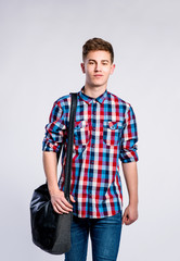 Fototapeta premium Boy in jeans and shirt, young man, studio shot
