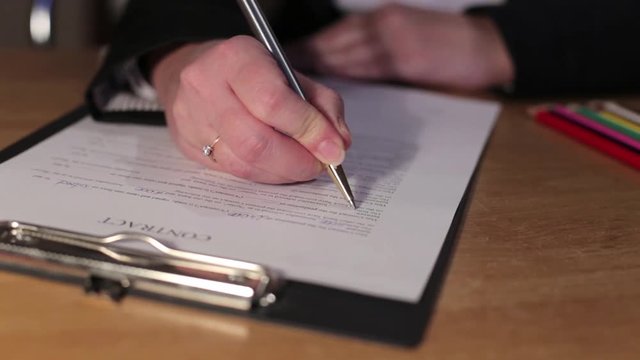 Woman Signs Agreement