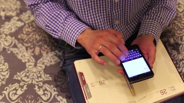Man doing calculations with a smartphone