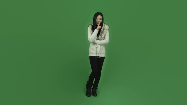 Asian girl young adult isolated greenscreen green background with a secret