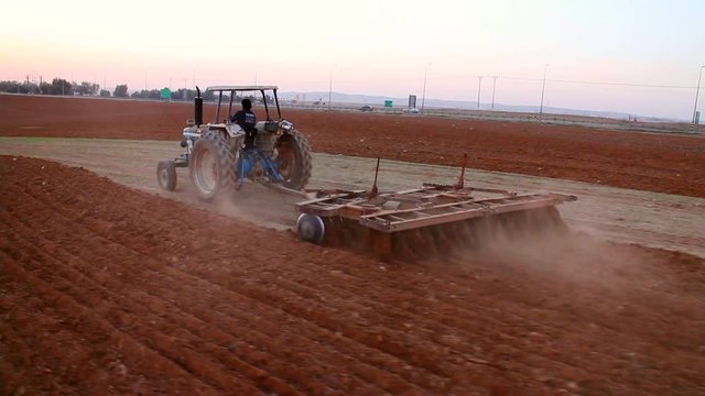 Tractor plowing the fild - aerial shot.