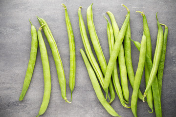 Green beans  on a gray background.