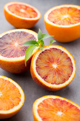 Mixed citrus fruit figs, limes on a gray background.