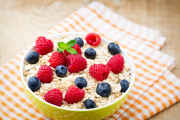 Oatmeal porridge with berries. Raspberries and blueberries.