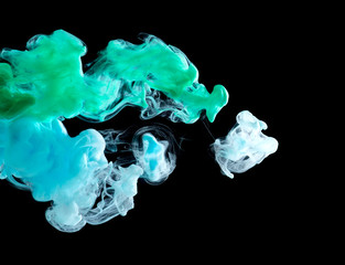 The clouds of paint in the dark water