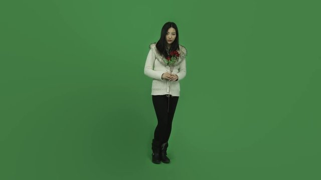 Asian girl young adult isolated greenscreen green background depressed romance with roses