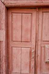 Fototapeta premium Antique door / old door / A weathered blue door / old wooden door / The Old Door with Cracked Paint Background / Door of an old abandoned building