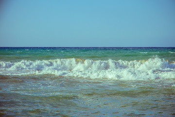 Beautiful wave on sea and blue sky with clouds