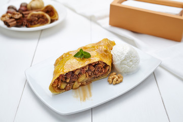 Traditional strudel with figs and nuts sweet healthy dessert on white plate