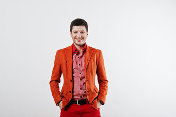 Obraz premium Fashion laughing young man in orange suit and red pants casual p