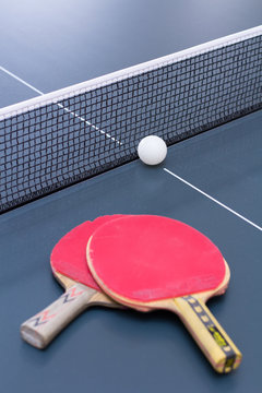 Ping Pong: composition of two old scratched rackets with grid and ball 