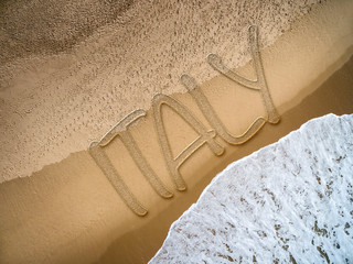 Italy written on the beach