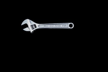 Adjustable wrench isolated on black background. - Silver Metal Monkey Wrench