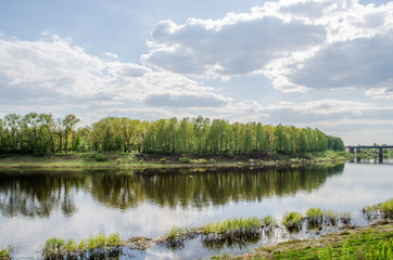 View above big beautiful river with blue sky and green grass in Belarus, Polotsk.