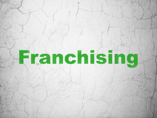 Business concept: Franchising on wall background