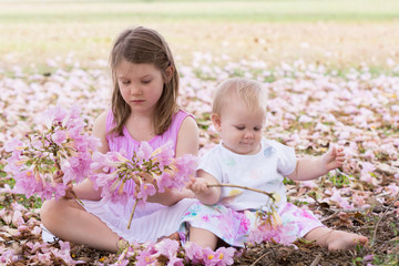 Sisters playing with flowers