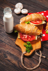 vegetarian croissant cheese breakfast on wood background